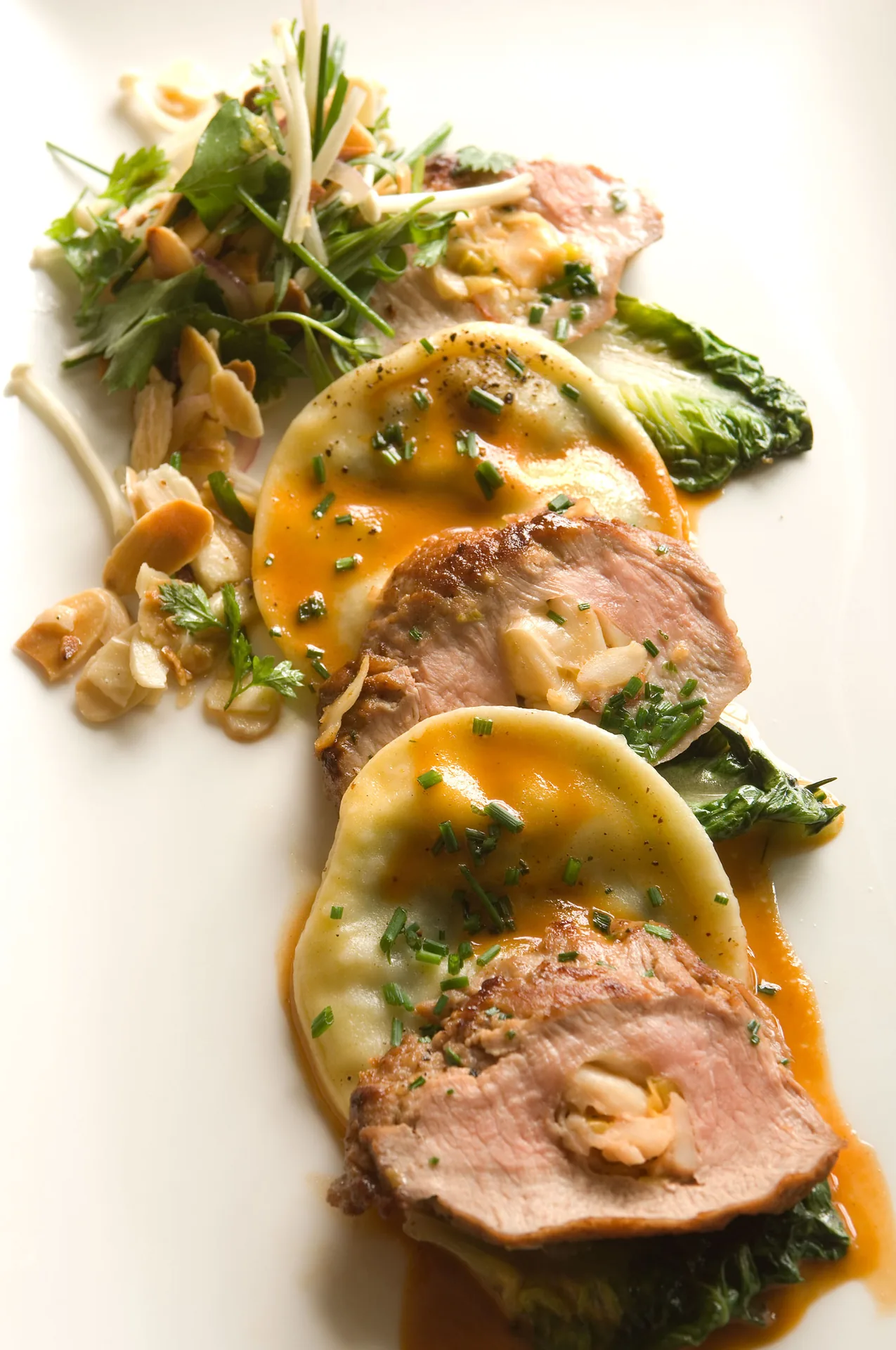 Lobster-Stuffed Veal Tenderloin with Goat Cheese and Quail Egg Ravioli background image