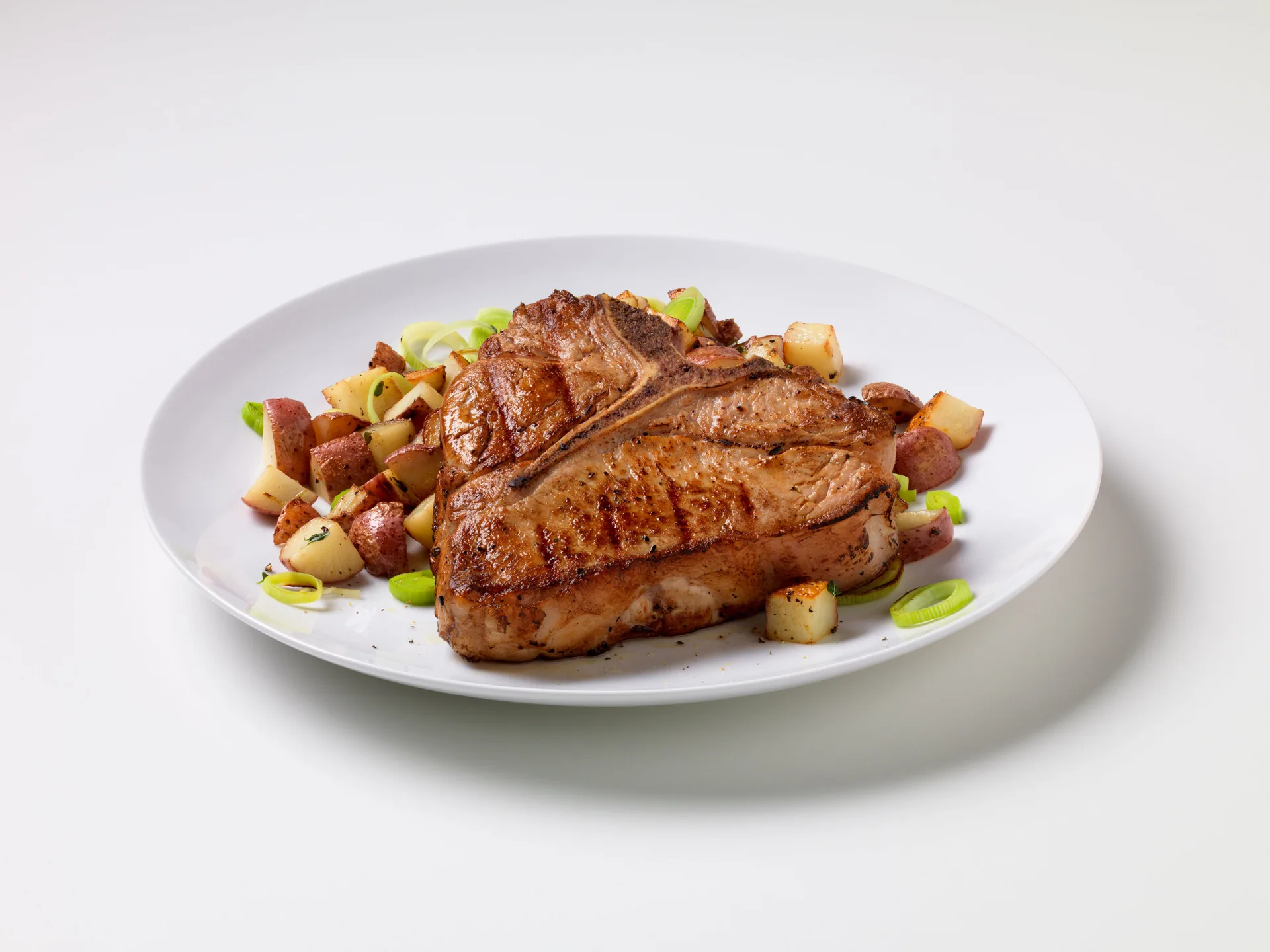 Grilled Veal Chops with Potato-Leek Hash background image
