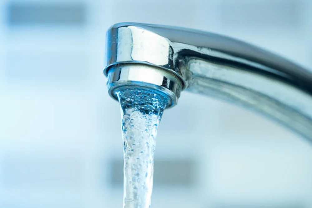Pouring water from a Faucet.