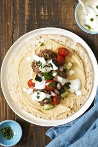 Ground Veal with onions and Middle Eastern spices served over basmati rice with yogurt sauce, tomato salad, hummus, and pita bread.