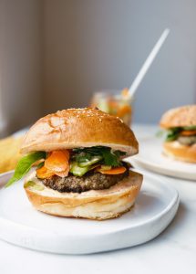 The Veal Banh Mi Burger: pickled vegetables, cilantro, and spicy Sriracha aioli on this perfect canvas.